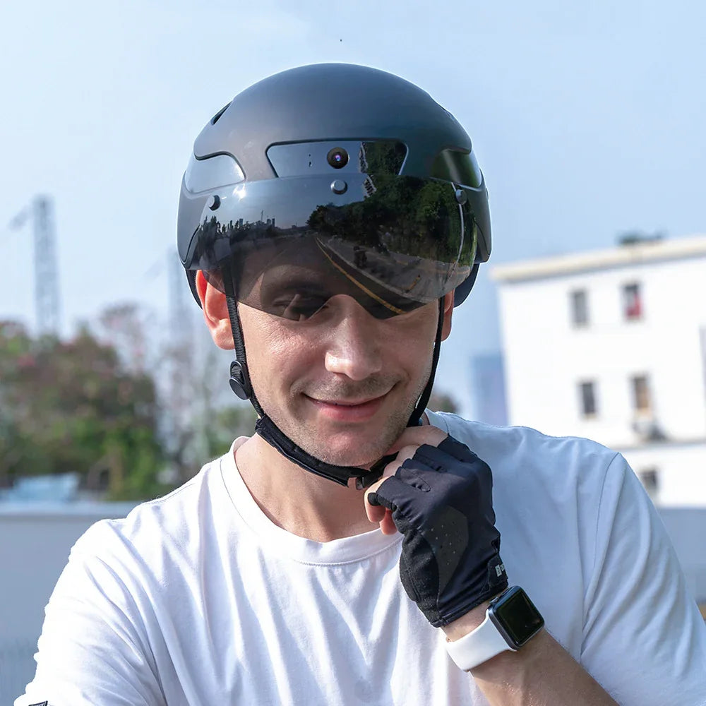 Urban rider wearing smart black helmet with visor outdoors, TrekGlow safety gear